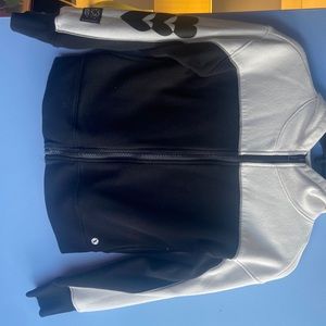 A zip up jacket, black, and white